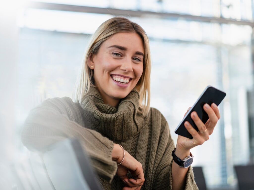 Woman using Financial Institution WiFi in a waiting room smiling - Datavalet - Datavalet